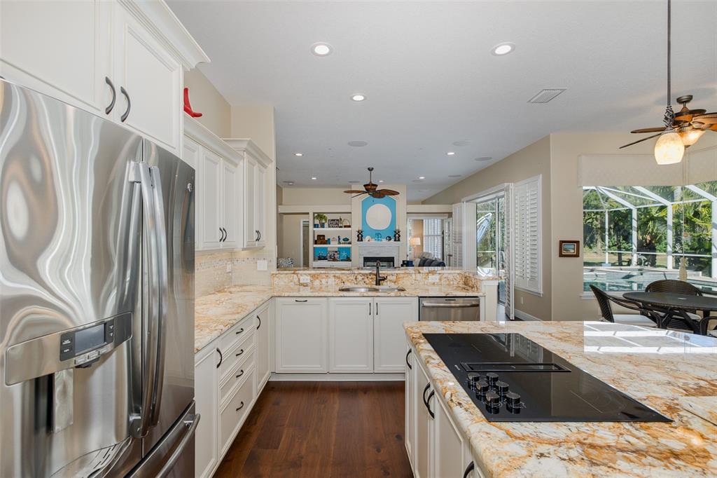 2928 Waters Edge Road Palm Harbor, FL 34685 - Photo 19 of 52 a kitchen with stainless steel appliances granite countertop a sink stove and refrigerator