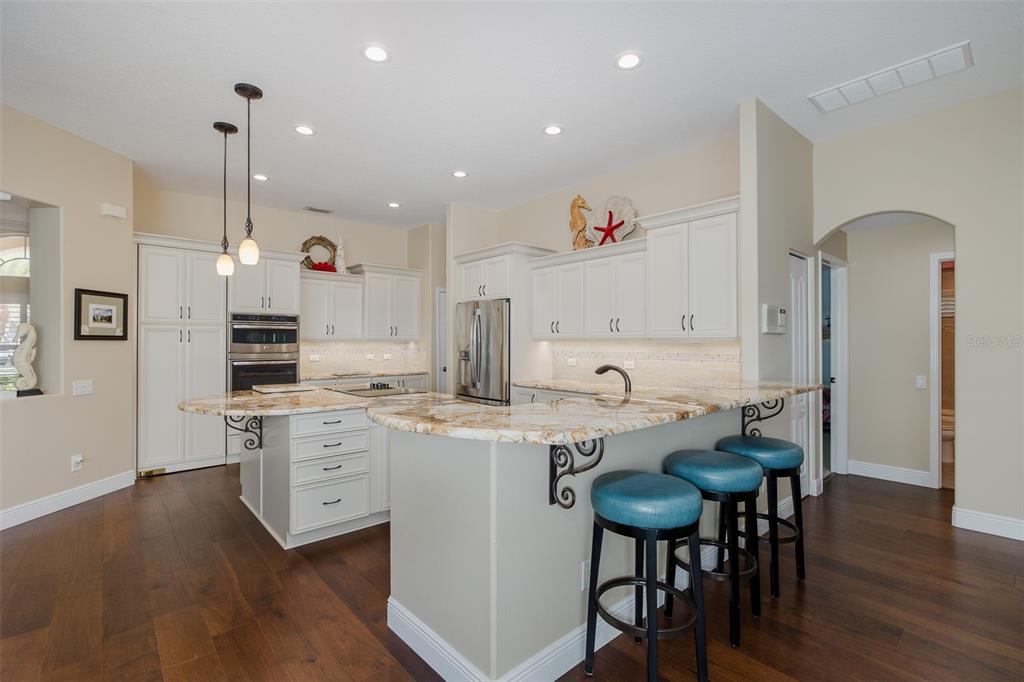 2928 Waters Edge Road Palm Harbor, FL 34685 - Photo 20 of 52 a kitchen that has a table and chairs in it