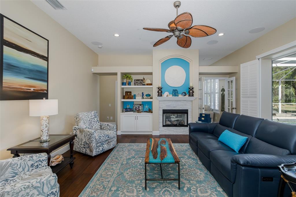 2928 Waters Edge Road Palm Harbor, FL 34685 - Photo 22 of 52 a living room with furniture fireplace and window