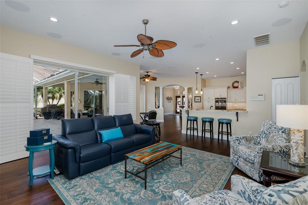 2928 Waters Edge Road Palm Harbor, FL 34685 - Photo 24 of 52 a living room with furniture a rug and a chandelier