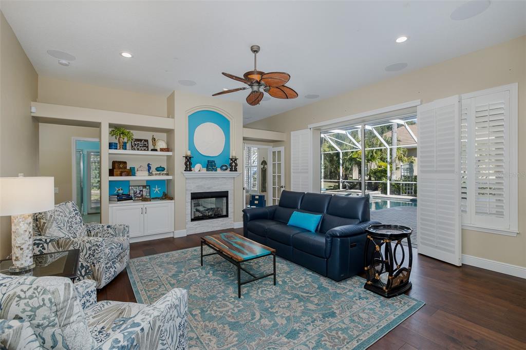 2928 Waters Edge Road Palm Harbor, FL 34685 - Photo 25 of 52 a living room with furniture a fireplace and a large window