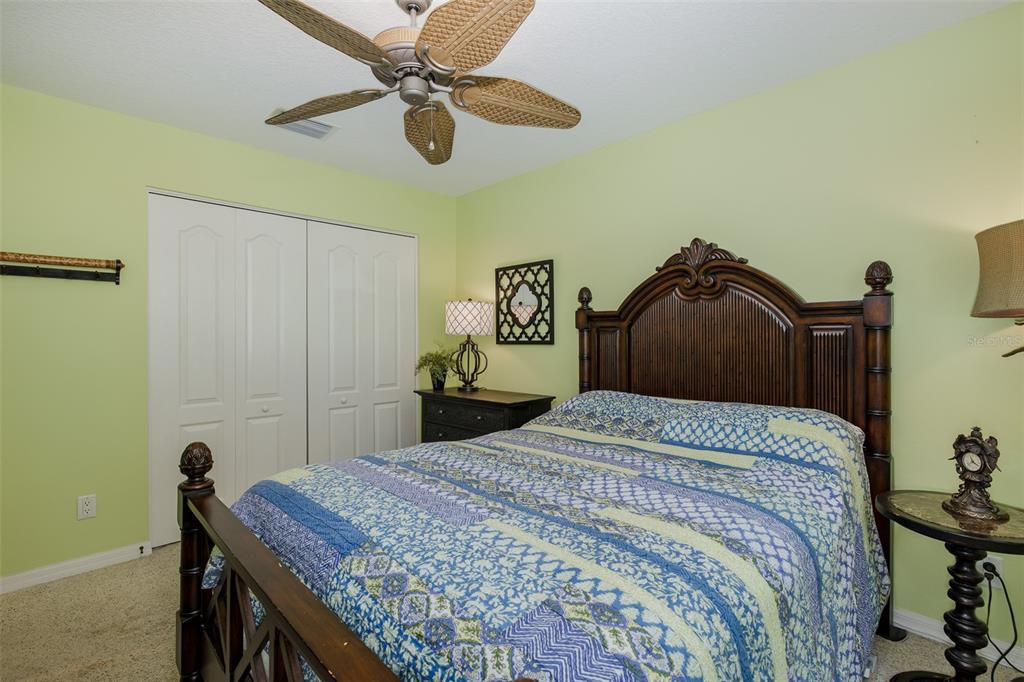2928 Waters Edge Road Palm Harbor, FL 34685 - Photo 27 of 52 a bedroom with a bed and a chandelier