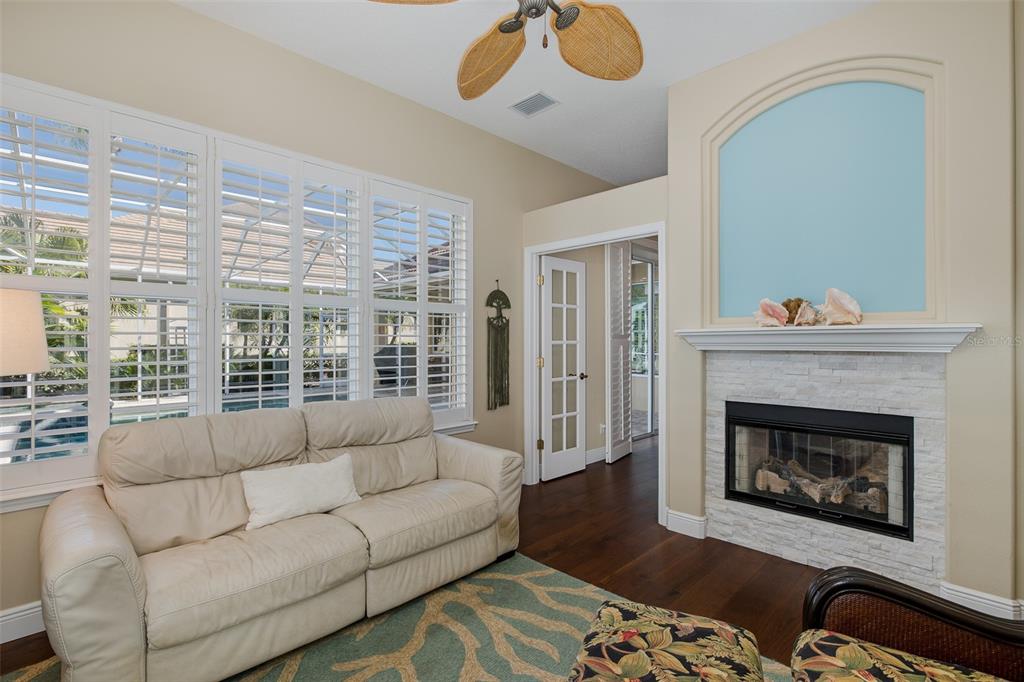 2928 Waters Edge Road Palm Harbor, FL 34685 - Photo 29 of 52 a living room with furniture and a fireplace