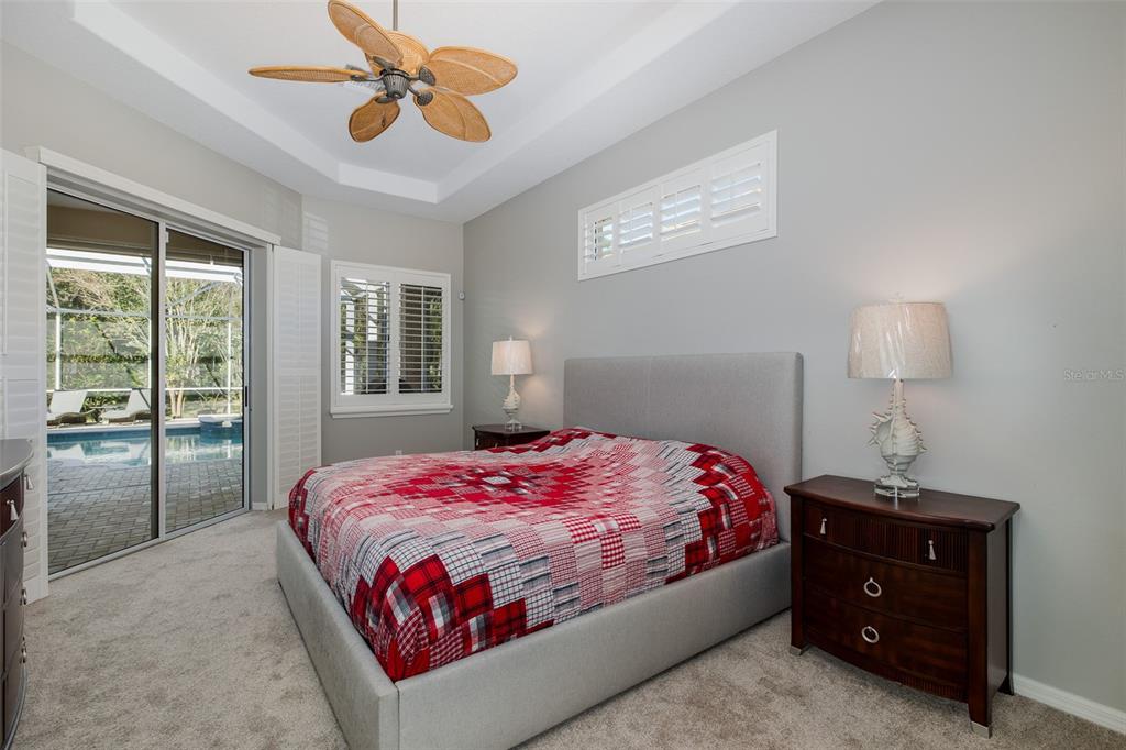2928 Waters Edge Road Palm Harbor, FL 34685 - Photo 32 of 52 a bedroom with a bed and wooden floor