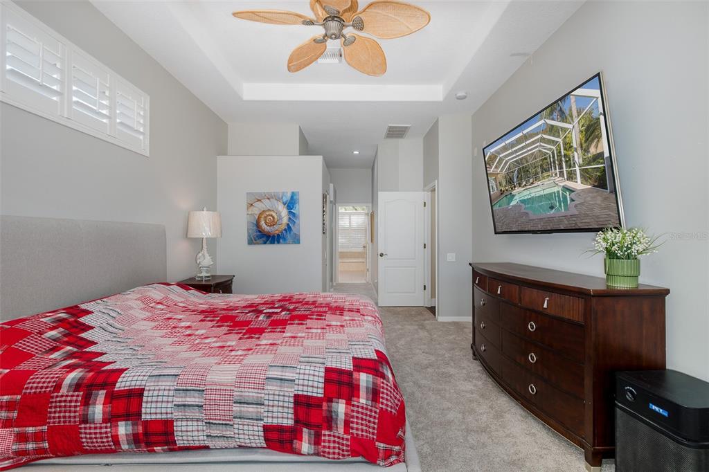 2928 Waters Edge Road Palm Harbor, FL 34685 - Photo 33 of 52 a bedroom with a bed and a dresser in it