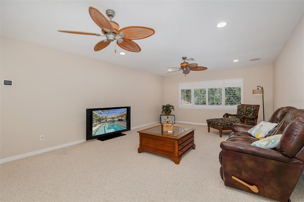 2928 Waters Edge Road Palm Harbor, FL 34685 - Photo 38 of 52 a living room with furniture and a large window