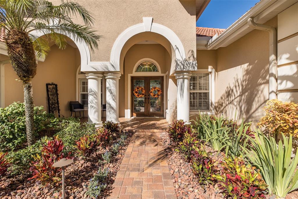 2928 Waters Edge Road Palm Harbor, FL 34685 - Photo 8 of 52 a view of a brick house with potted plants