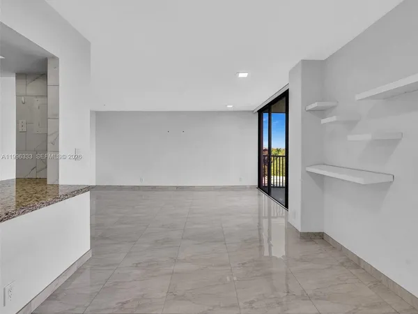 a view of a kitchen with a sink and mirror