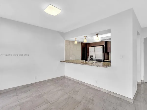 a large white kitchen with a sink and cabinets