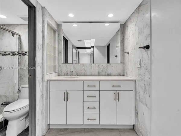 a bathroom with a granite countertop sink mirror and double