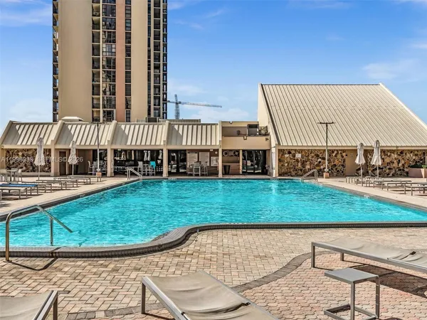 a swimming pool with outdoor seating