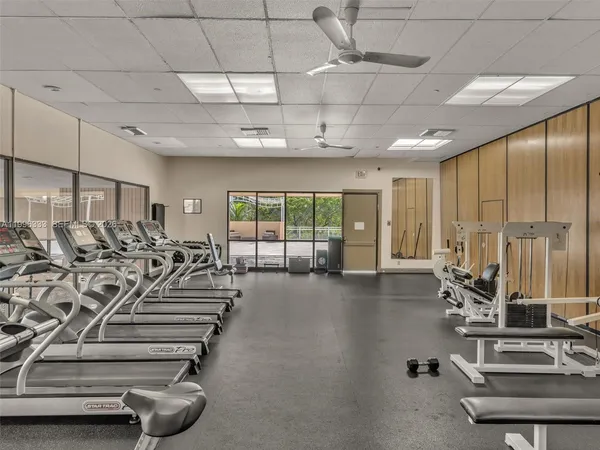 a dining hall with lots of tables and chairs