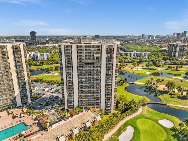 a view of a park with plants and palm trees