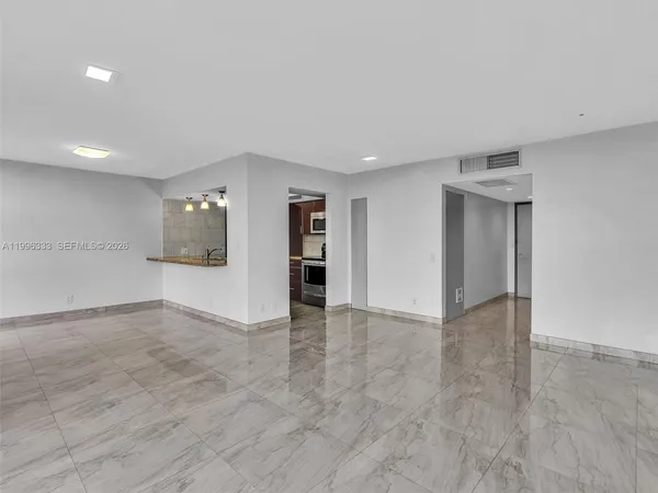 an empty room with an empty space and window