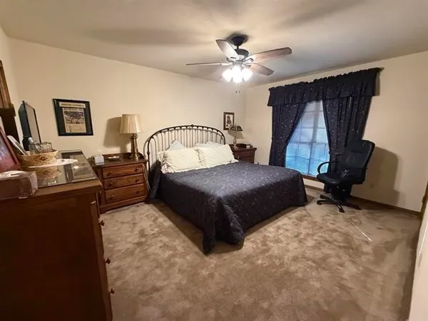 a large bedroom with a bed and furniture