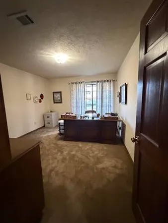 a view of a workspace with furniture