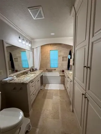 a large bathroom with a granite countertop sink a mirror and a shower