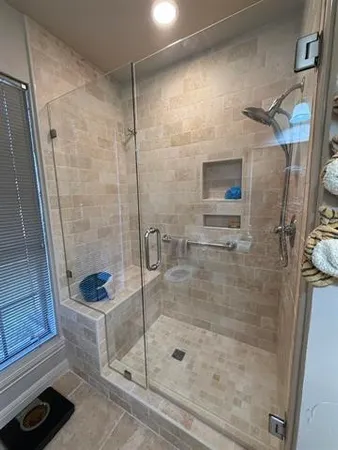 a bathroom with a toilet and a shower
