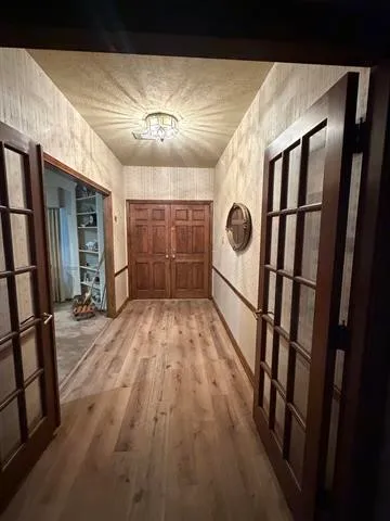 a living room with furniture a flat screen tv and a large window