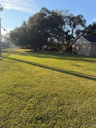 a front view of house with a garden