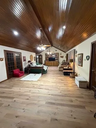 a kitchen with stainless steel appliances granite countertop wooden cabinets a sink and dishwasher a stove top oven with wooden floor