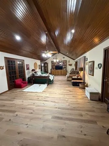 a kitchen with stainless steel appliances granite countertop wooden cabinets a sink and dishwasher a stove top oven with wooden floor