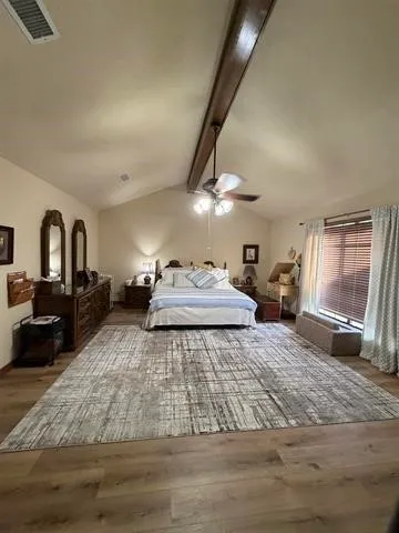 a bedroom with a bed couch and a window