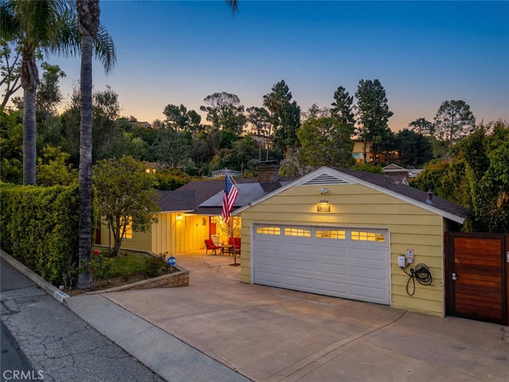 660 Woodbury Road Glendale, CA 91206 - Photo 1 of 45 a front view of a house with a yard and garage