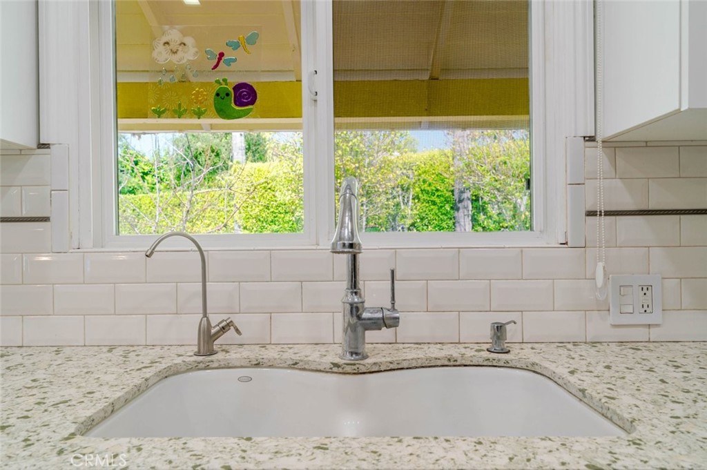 660 Woodbury Road Glendale, CA 91206 - Photo 12 of 45 a bathroom with a granite countertop sink and a window