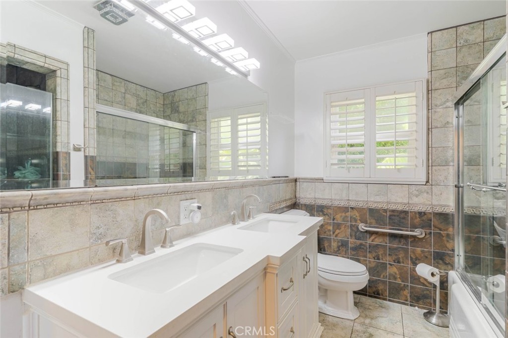660 Woodbury Road Glendale, CA 91206 - Photo 17 of 45 a bathroom with a sink toilet vanity and shower