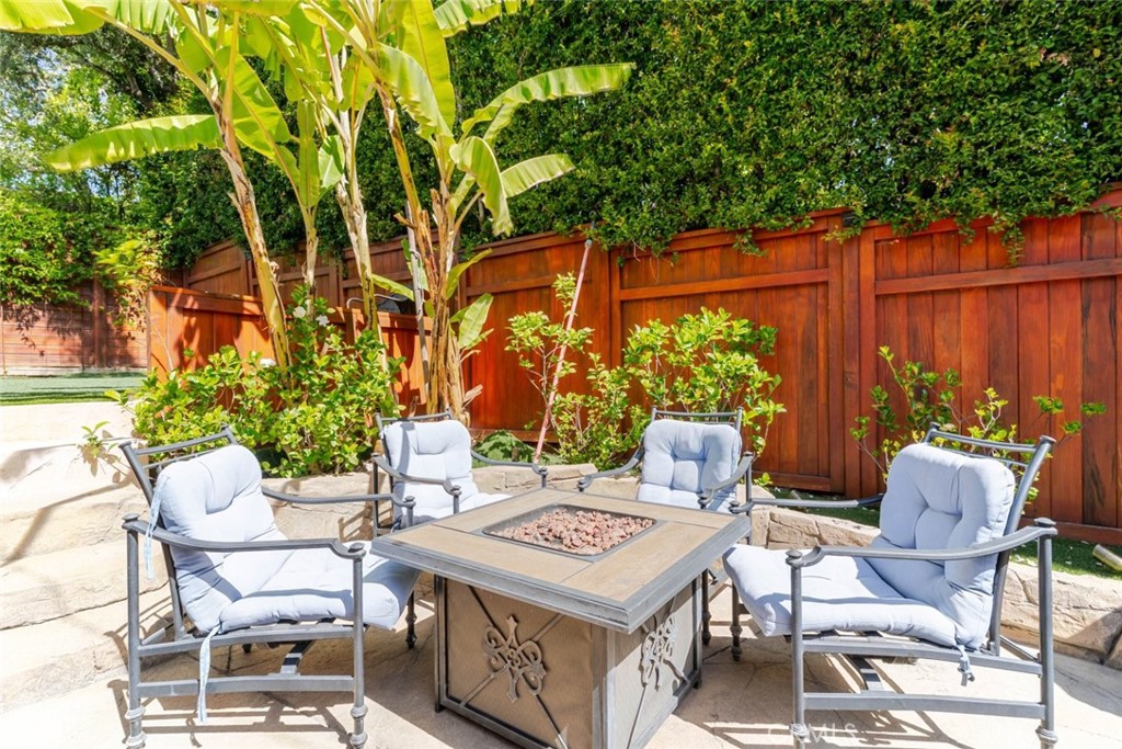 660 Woodbury Road Glendale, CA 91206 - Photo 33 of 45 a view of a patio with table and chairs potted plants and large tree