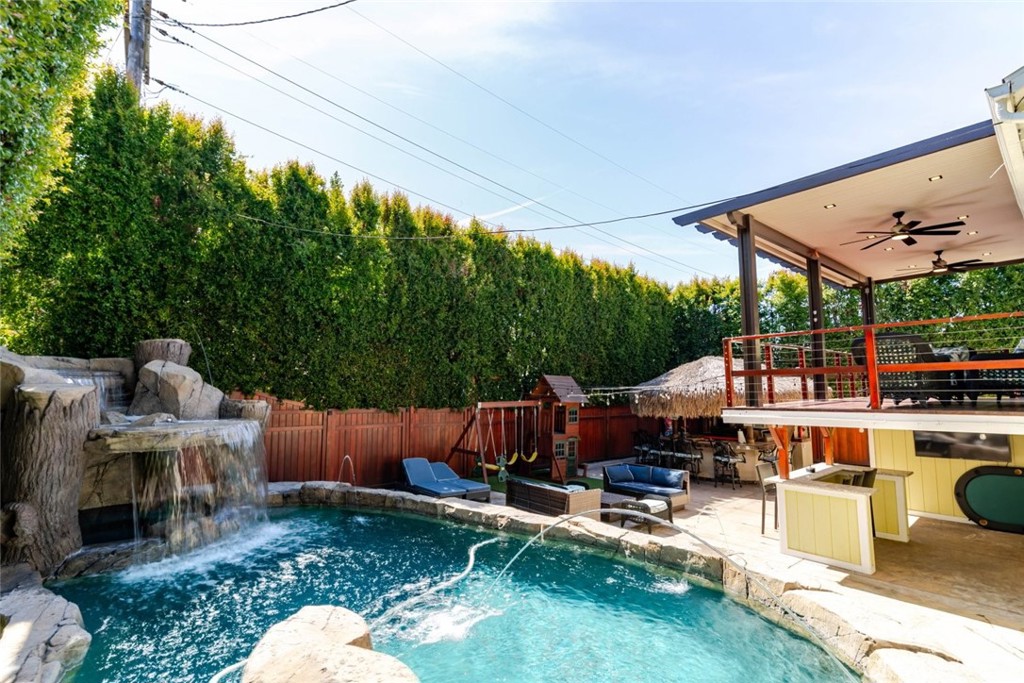 660 Woodbury Road Glendale, CA 91206 - Photo 34 of 45 a view of a patio with table and chairs potted plants and a palm tree