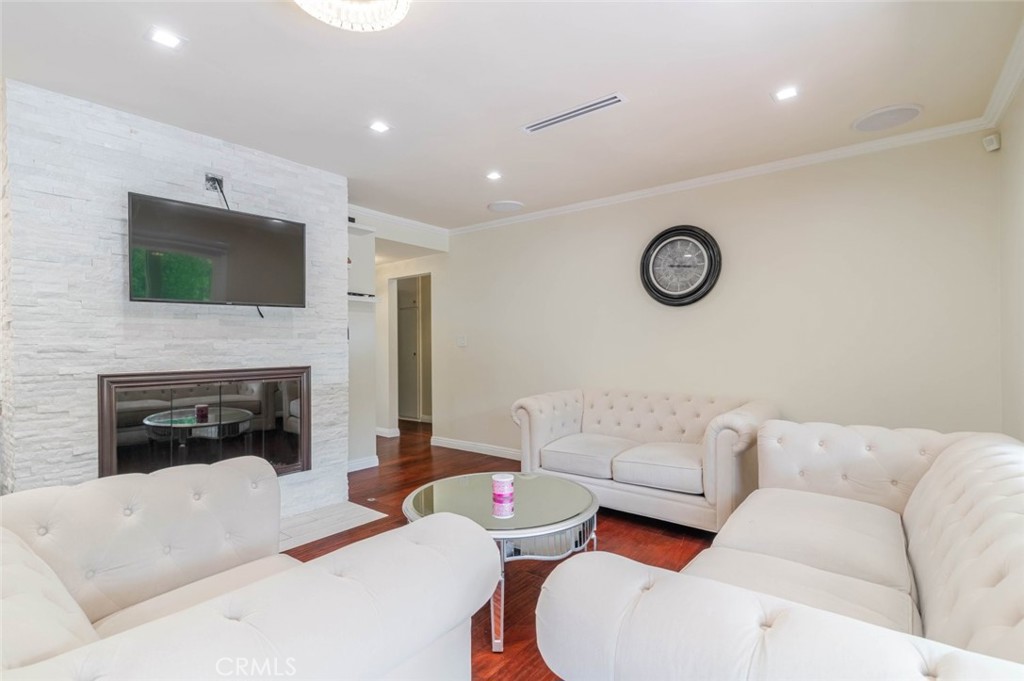660 Woodbury Road Glendale, CA 91206 - Photo 5 of 45 a living room with furniture a fireplace and a flat screen tv