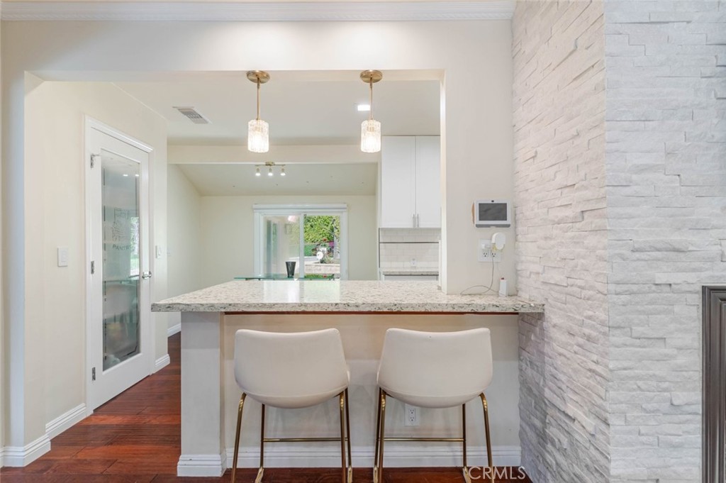 660 Woodbury Road Glendale, CA 91206 - Photo 6 of 45 a dining table with chairs and wooden floor
