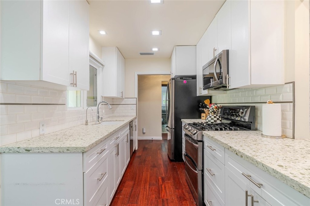 660 Woodbury Road Glendale, CA 91206 - Photo 7 of 45 a kitchen with stainless steel appliances granite countertop a sink stove and refrigerator