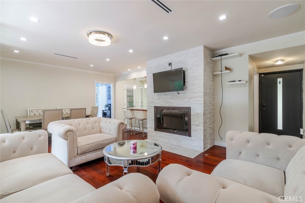 660 Woodbury Road Glendale, CA 91206 - Photo 10 of 45 a living room with furniture fireplace and a flat screen tv