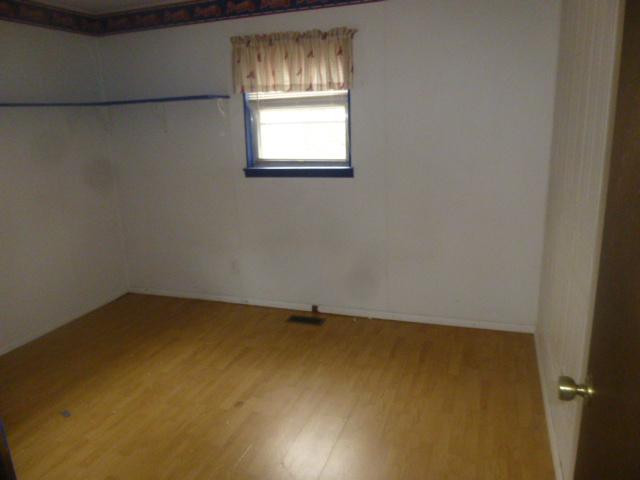 490 Powell Hollow Road Tullahoma, TN 37388 - Photo 7 of 10 Bedroom 3 with laminate flooring. All three bedrooms in this home are spacious