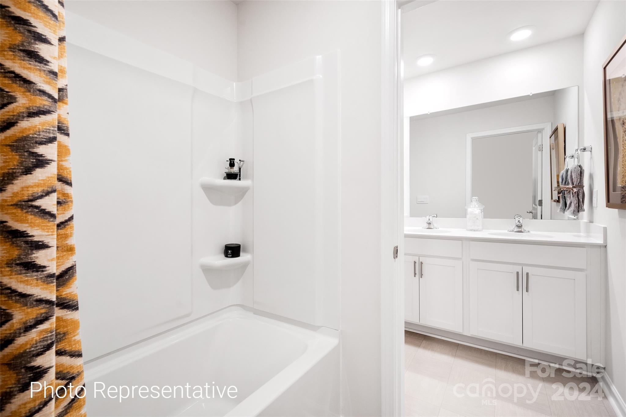 244 Wheatfield Road Fletcher, NC 28732 - Photo 20 of 29 a bathroom with a sink a mirror and shower