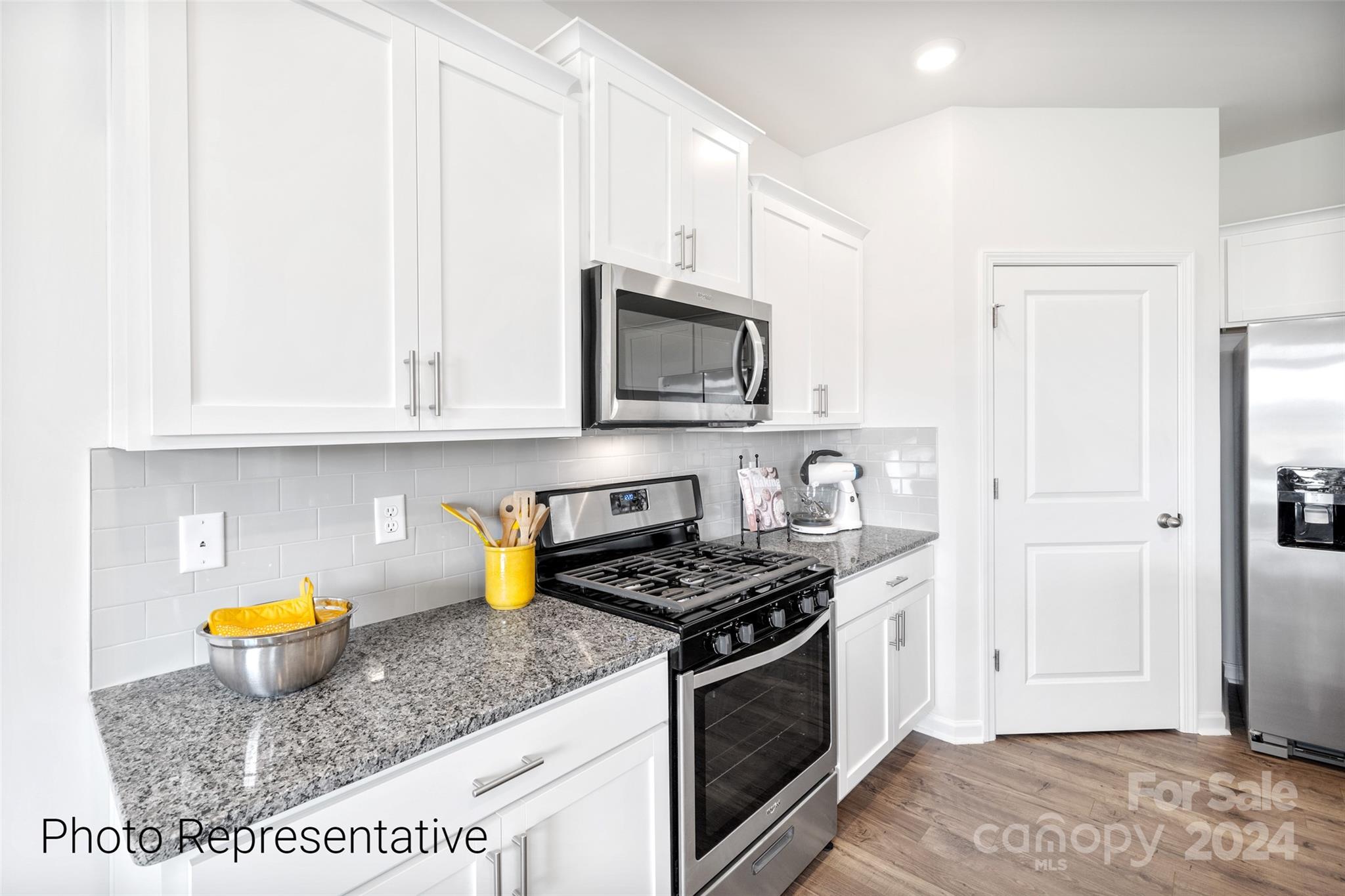 244 Wheatfield Road Fletcher, NC 28732 - Photo 8 of 29 a kitchen with stainless steel appliances granite countertop a stove a sink and a microwave