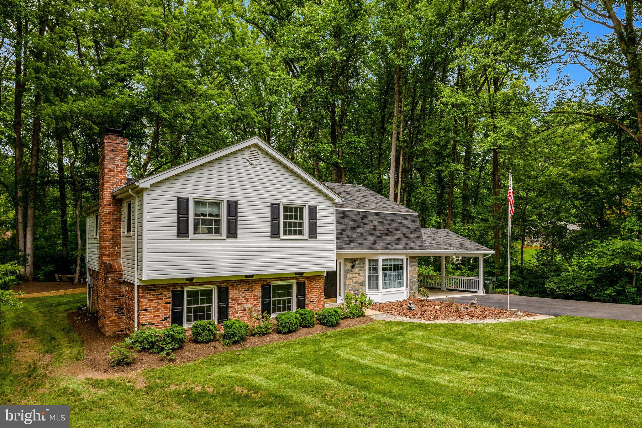 2042 Carrhill Road Vienna, VA 22181 - Photo 3 of 80 a front view of a house with a yard table and chairs