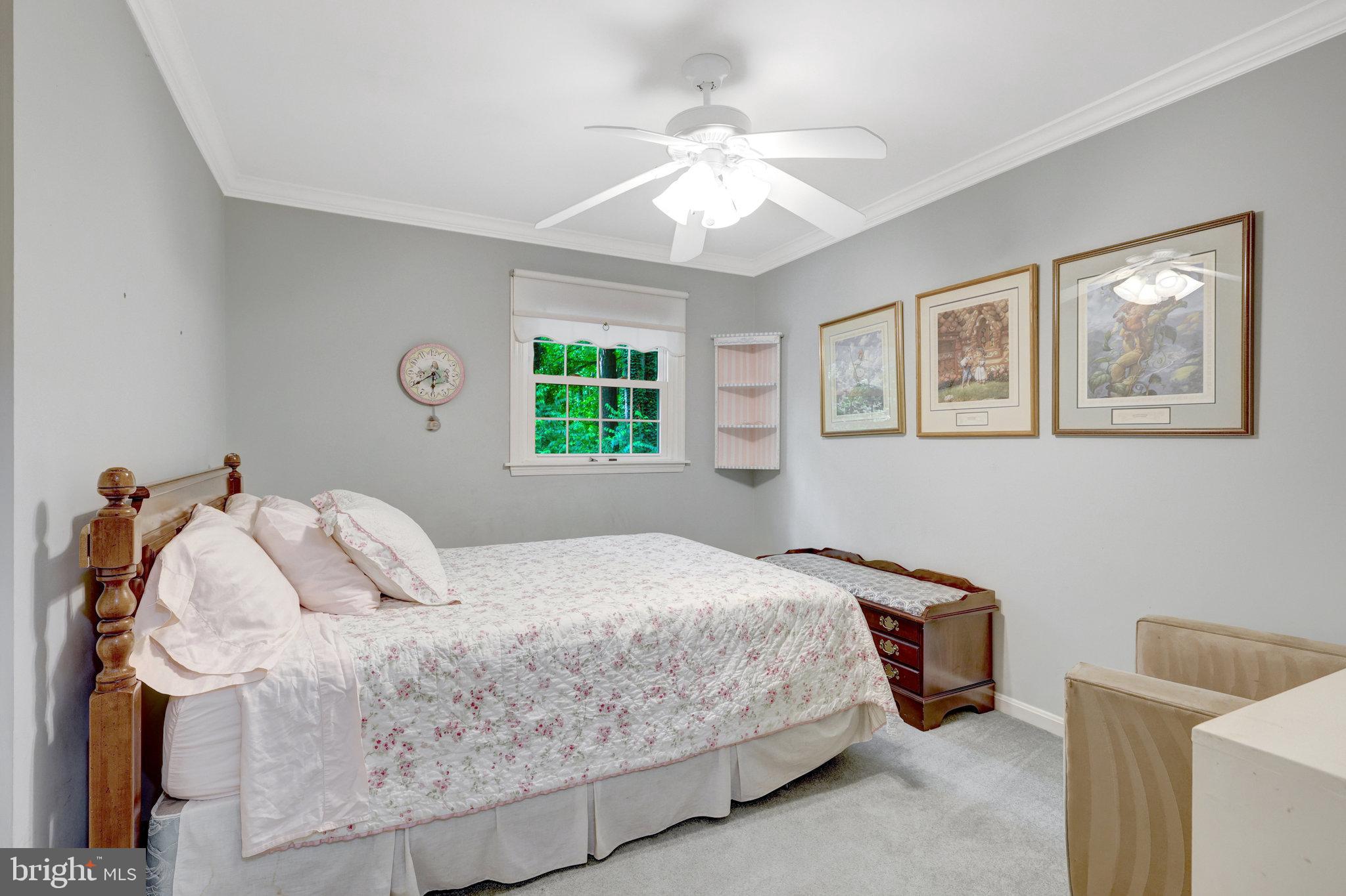 2042 Carrhill Road Vienna, VA 22181 - Photo 40 of 80 a bedroom with a bed and a chandelier