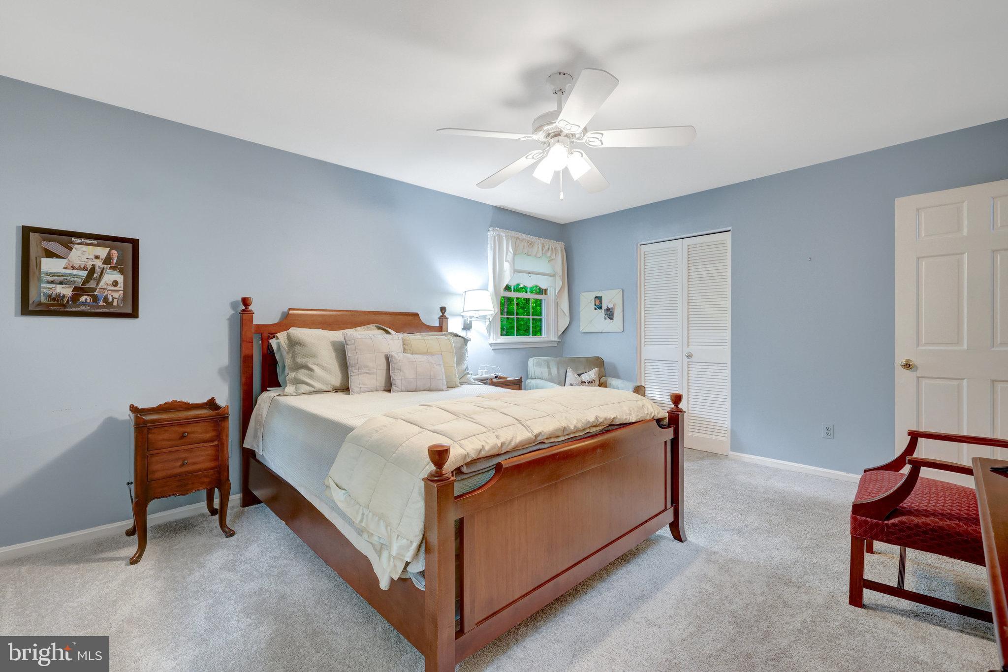 2042 Carrhill Road Vienna, VA 22181 - Photo 45 of 80 a spacious bedroom with a bed and a chandelier