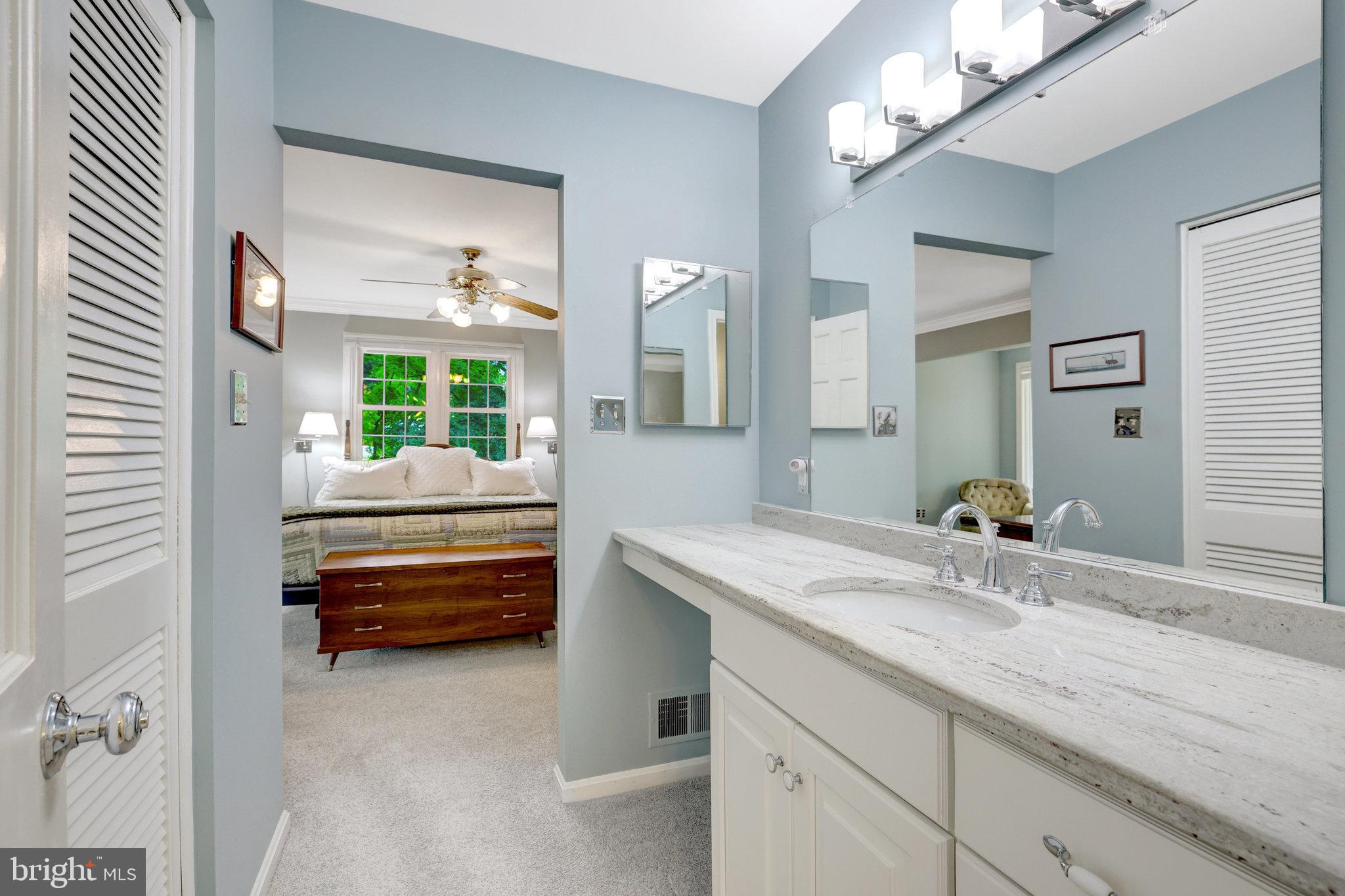 2042 Carrhill Road Vienna, VA 22181 - Photo 55 of 80 a bathroom with a granite countertop sink a toilet and a mirror