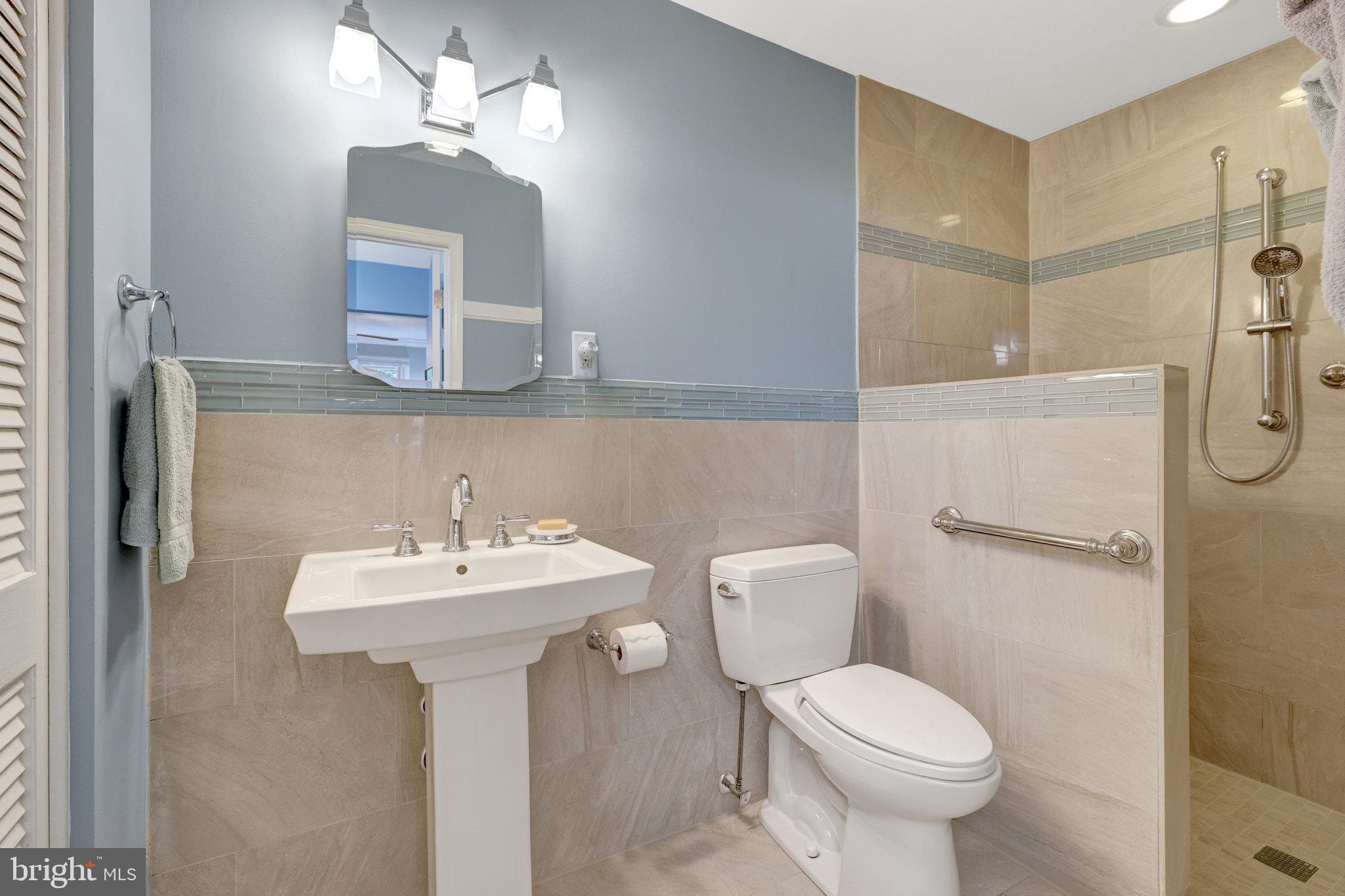 2042 Carrhill Road Vienna, VA 22181 - Photo 56 of 80 a bathroom with a sink mirror toilet and shower