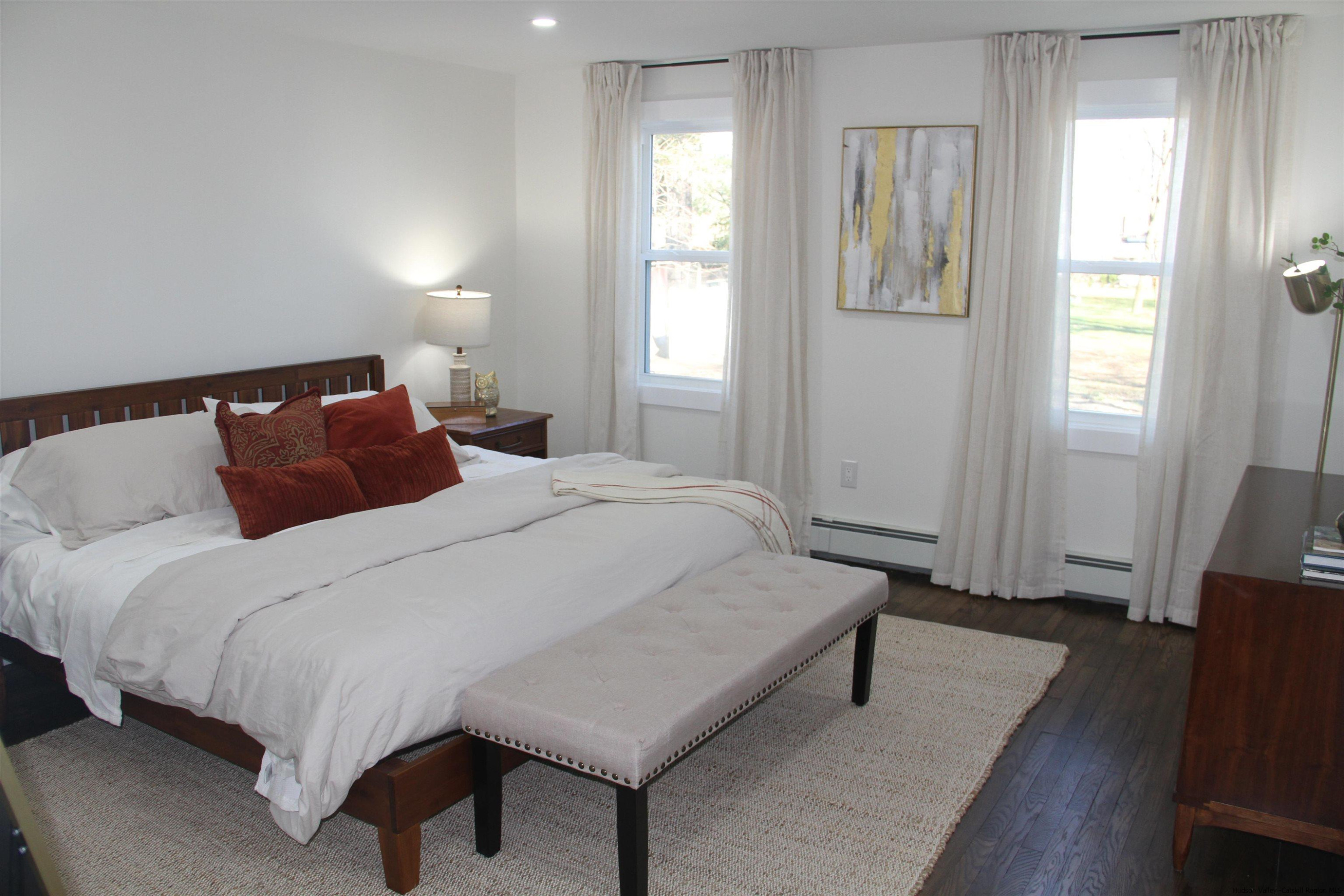 246 Jefferson Heights Catskill, NY 12414 - Photo 12 of 35 a bedroom with a bed and wooden floor