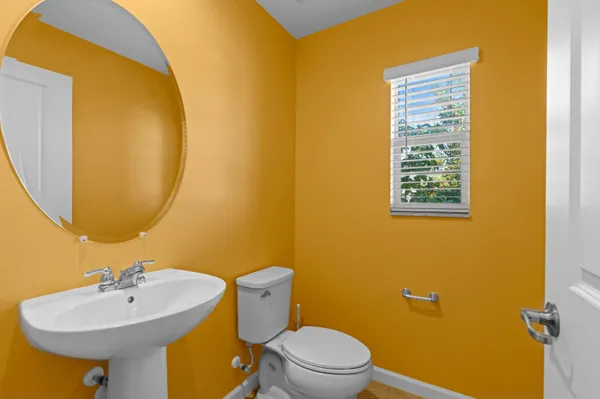 a bathroom with a sink mirror and toilet