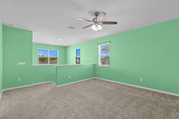 a view of room with window and ceiling fan