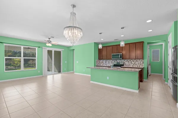 a view of kitchen and kitchen with microwave