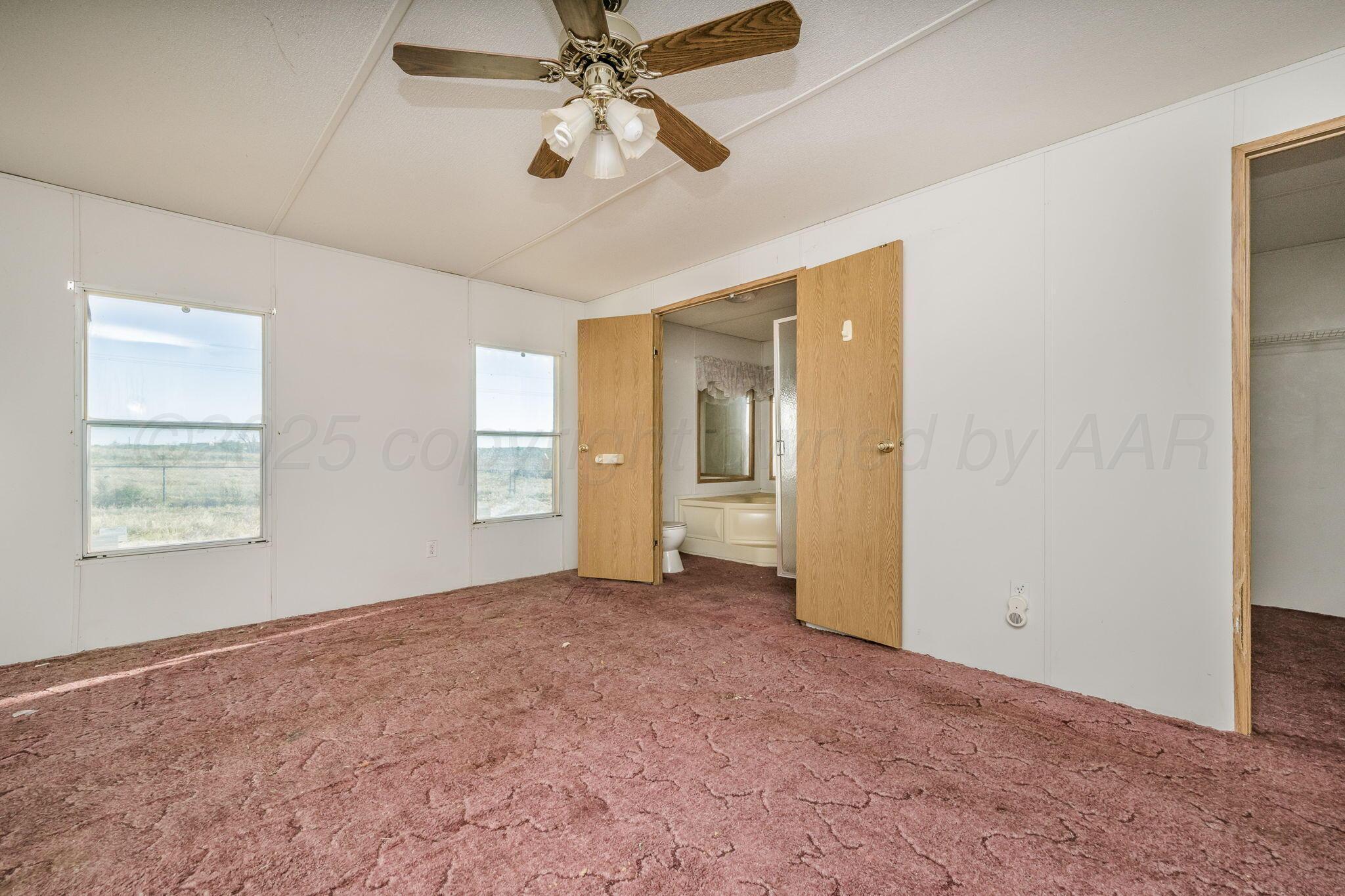 1061 Tascosa Road Amarillo, TX 79124 - Photo 13 of 31 a view of an empty room with a window
