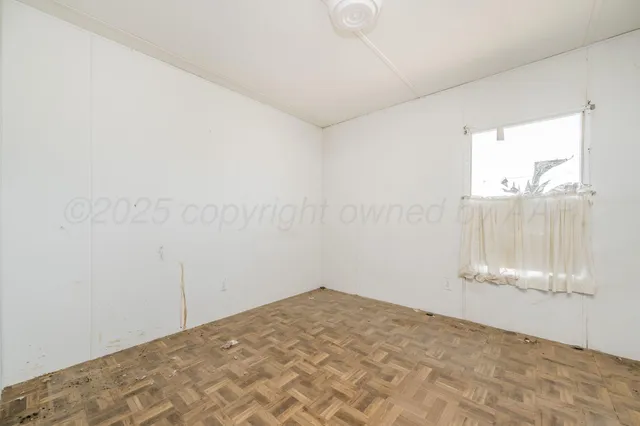 a view of an empty room and a window